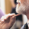 close up of bearded man scratching his chin